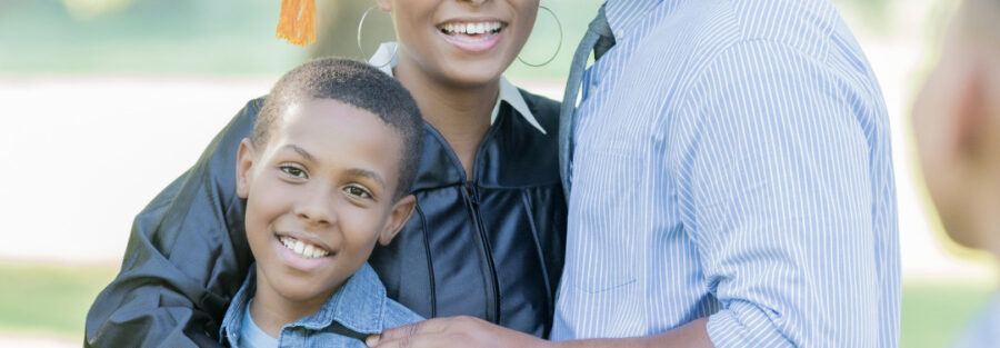 A flyer with picture of a black family, and the text on it reads ' Travel to the UK with your Family in 2025 - Study a Masters by Research Course'